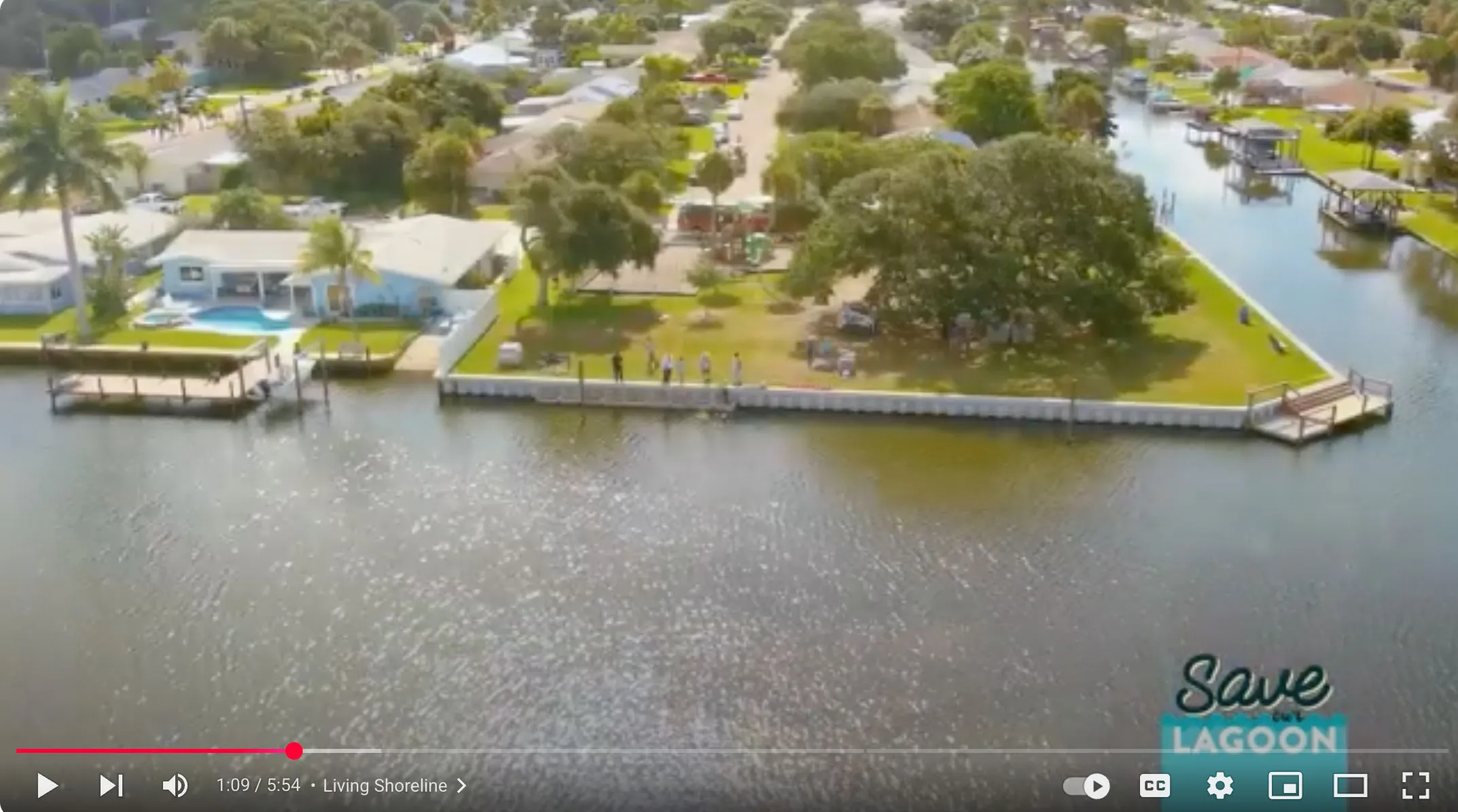 Aerial view of a residential seawall along the Indian River Lagoon with the Save Our Indian River Lagoon program logo overlayed, used in a living shoreline video.