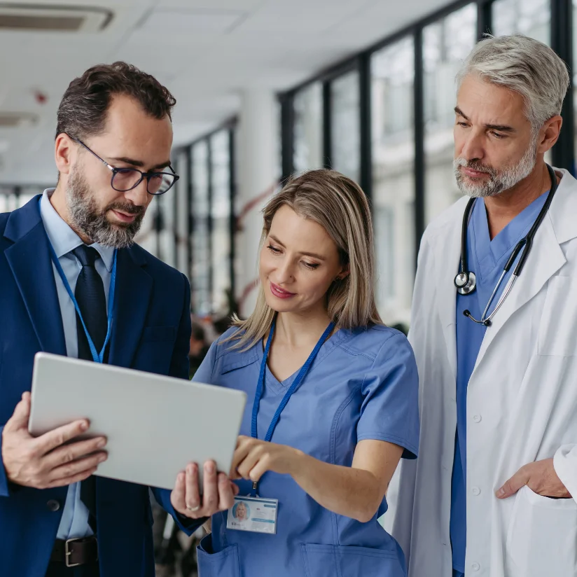 A medical sales representative going over the medical device order with the clinicians that placed the order.