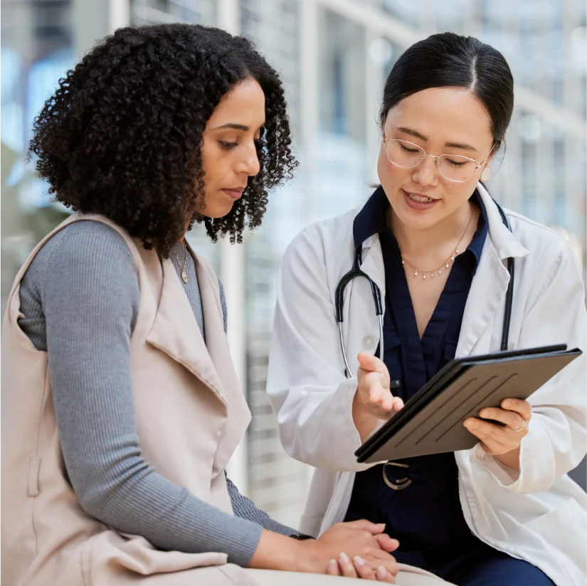 A physician discussing her patients plan of action and explaining the medical device that will aid in her recovery.