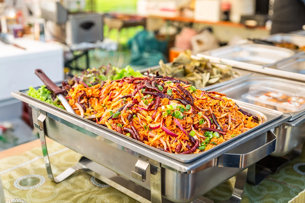 Buffet-style setup at a Scottsdale outdoor wedding venue with multiple food stations and guests mingling.