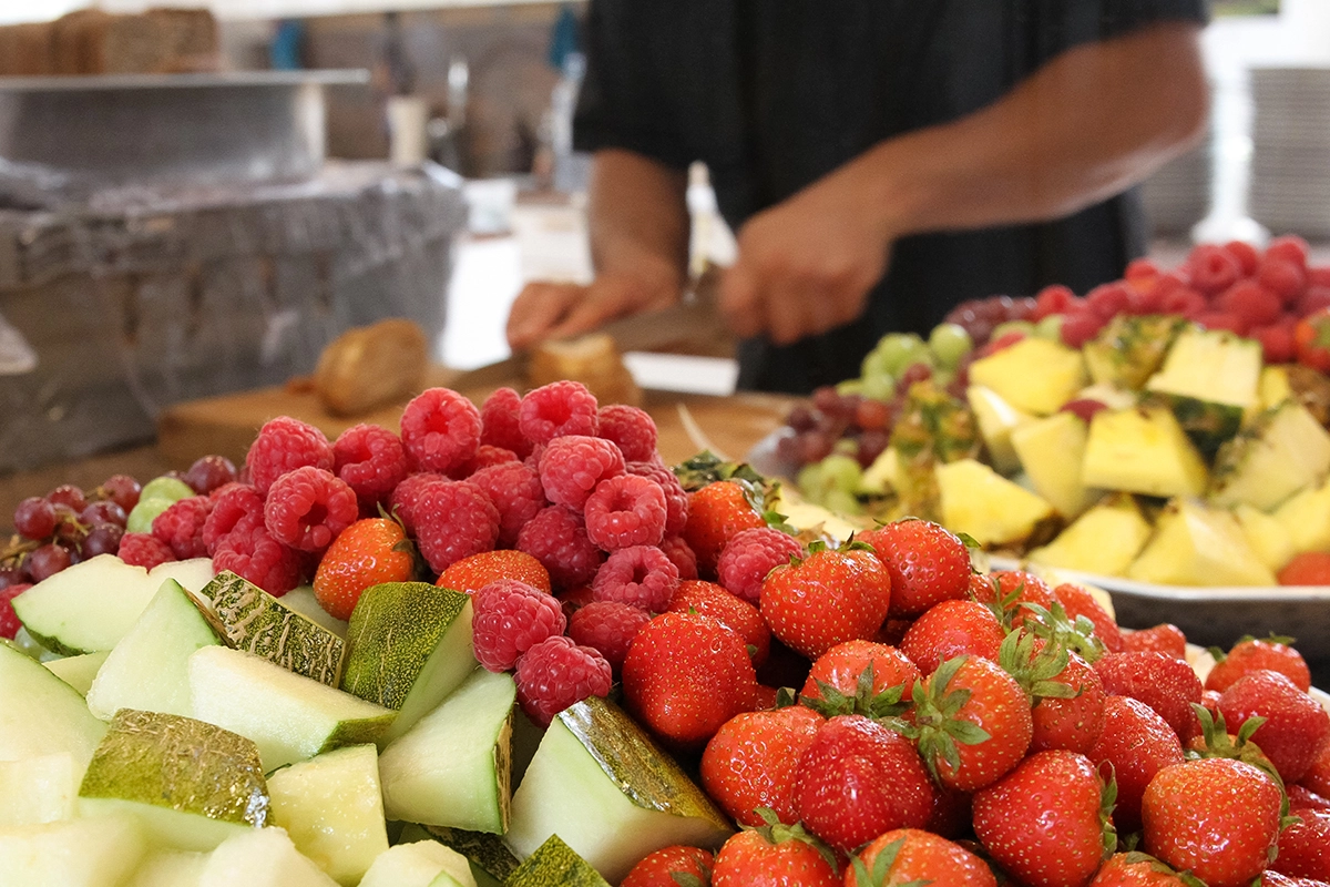 Bright brunch wedding buffet with mimosa bar and seasonal fruit at an outdoor Scottsdale venue.