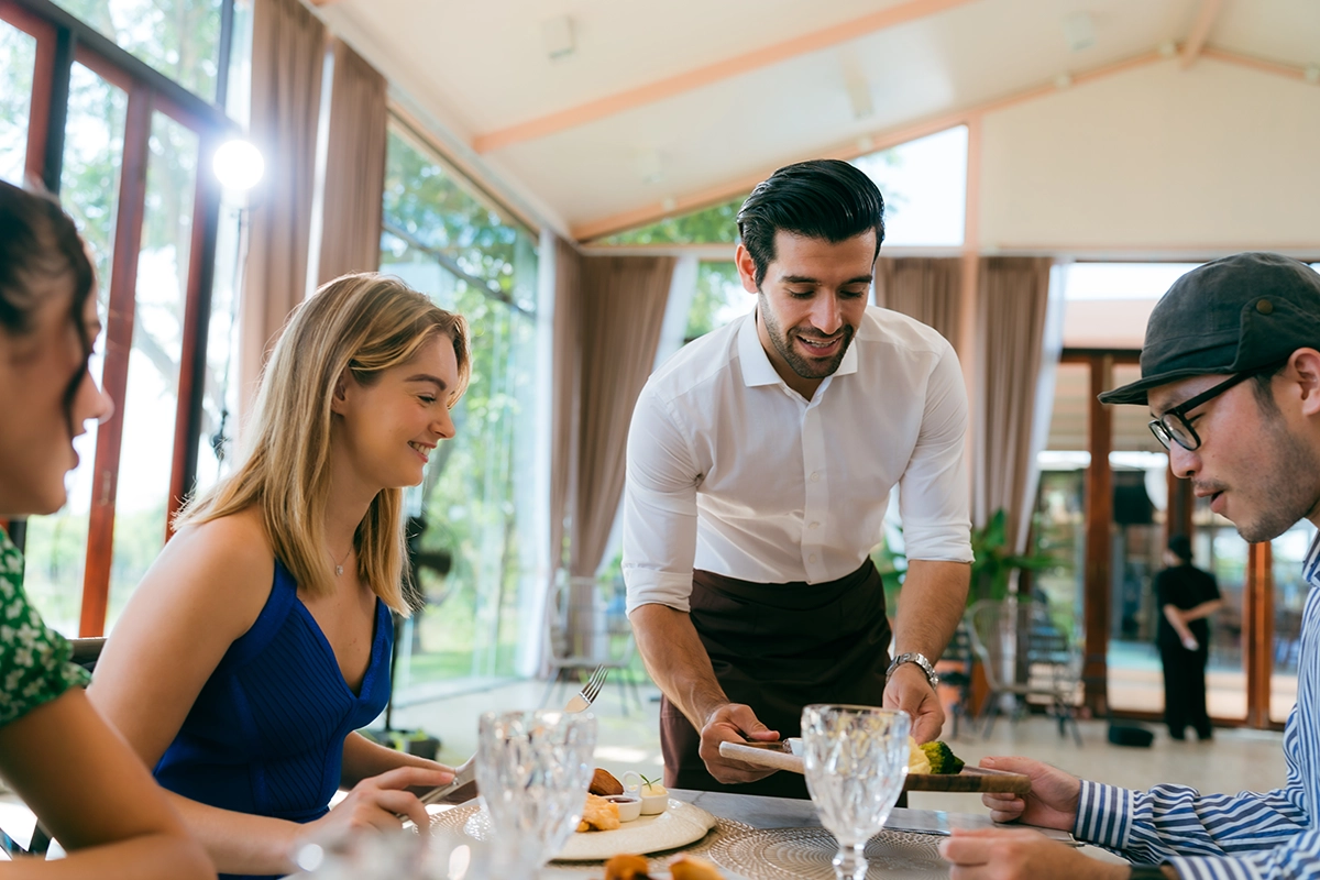 Guests interacting with a personal chef during an intimate Scottsdale dinner, learning about dishes and ingredients.