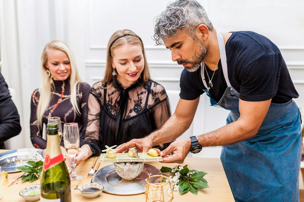 Guests watching a private chef cook during an in-home dining experience in Scottsdale
