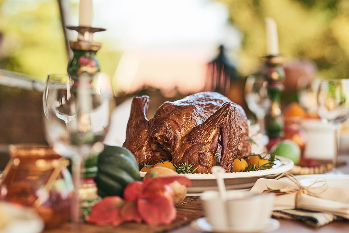 Thanksgiving dinner table set on a Scottsdale patio at sunset with desert mountains behind it.