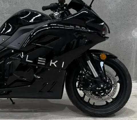 Close-up of the Leki's gloss-black front fairing, wordmark and front wheel