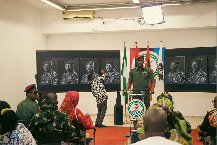 A room of congregation at a conference event with a man standing at the podium