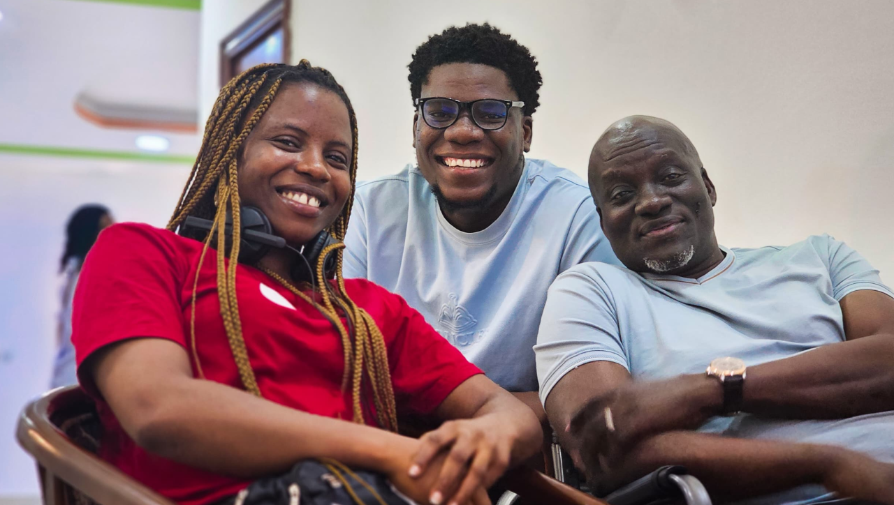 three people on a film set smiling for a picture