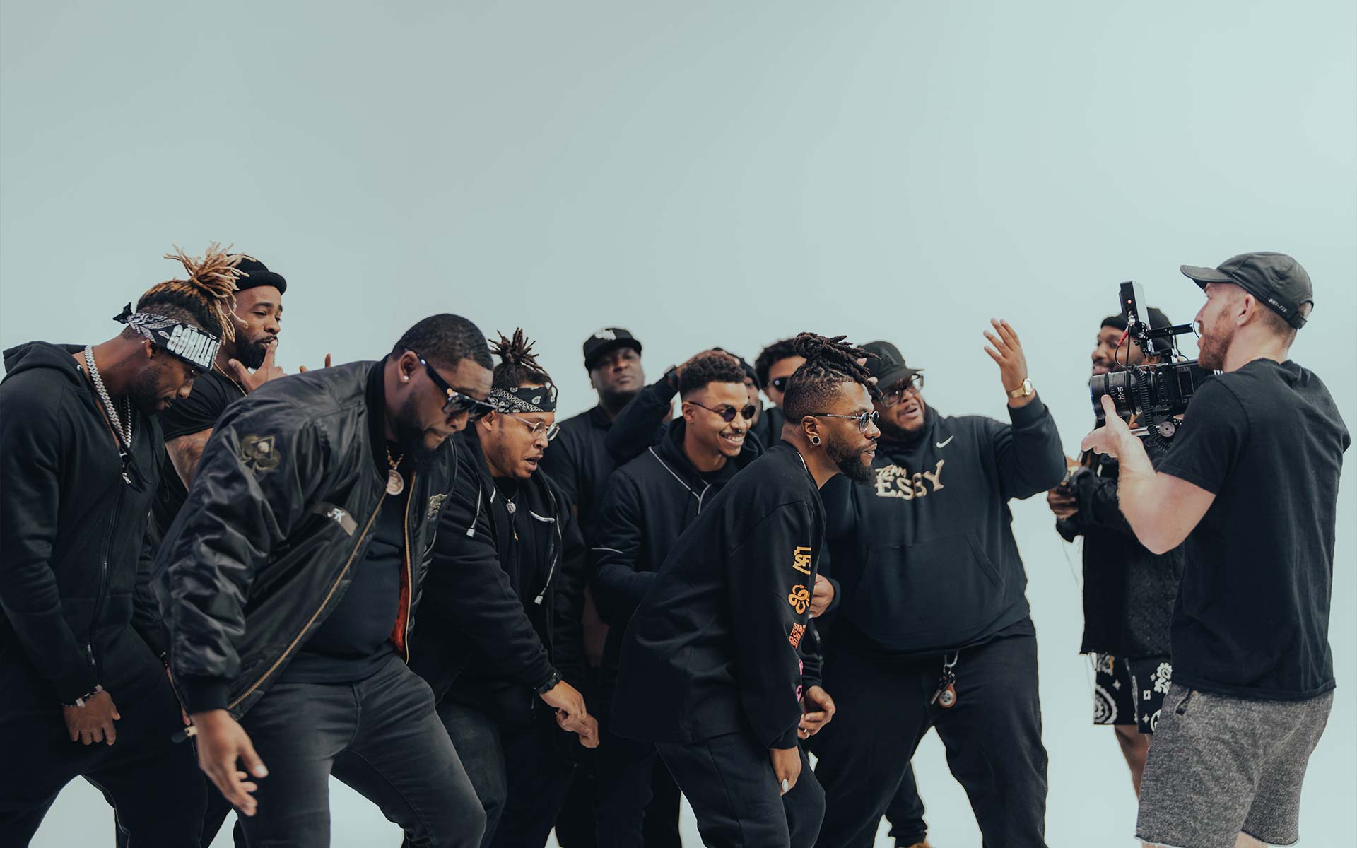 A videographer films a group of people.