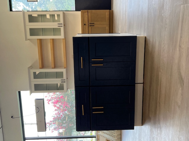 An elite cabinets display of dark colored cabinets inside of B&A Flooring Center's showroom