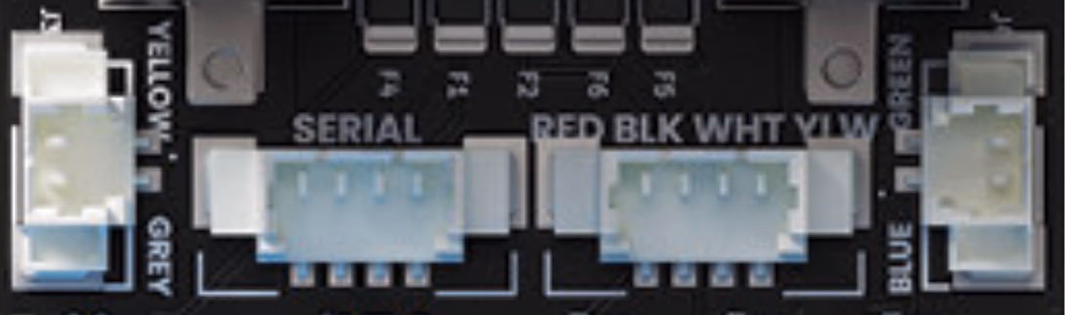 Close-up of electronic board connectors labeled SERIAL and WIRE COLORS with white connectors.