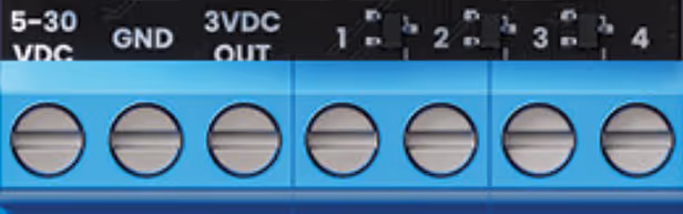 Close-up of a blue terminal block with eight round slots and labels for VDC, GND, and 3VDC output.