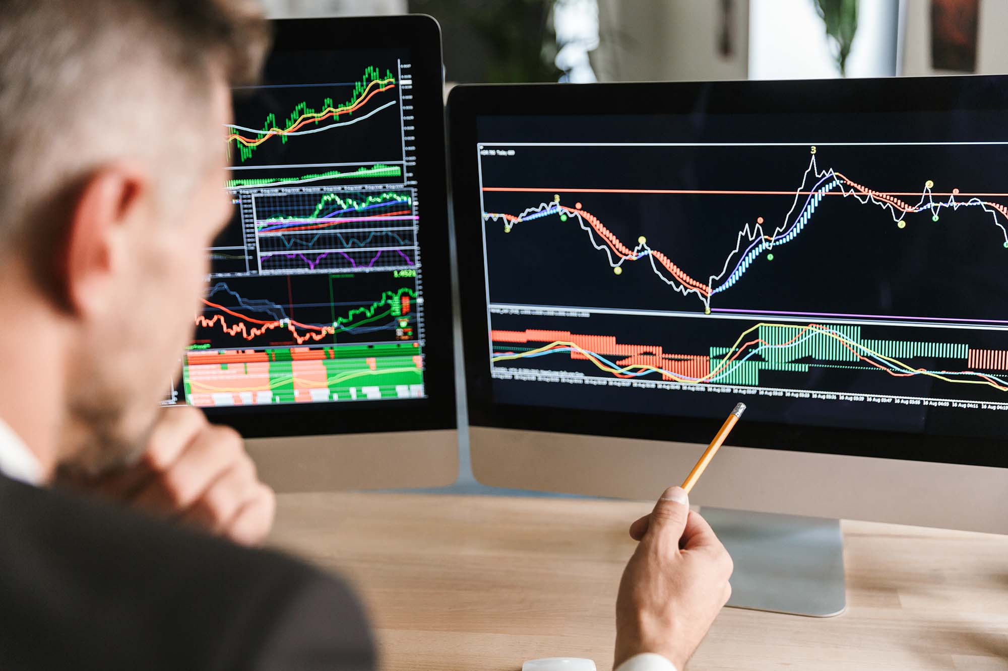 man looking at trading charts - Can You Start Day Trading With $100