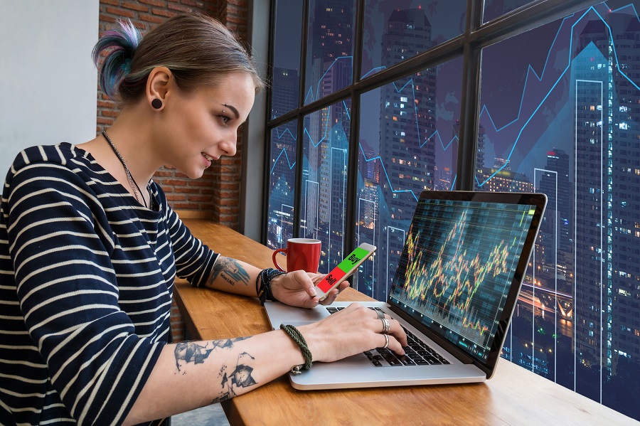 woman trading near a window - Can You Start Day Trading With $100