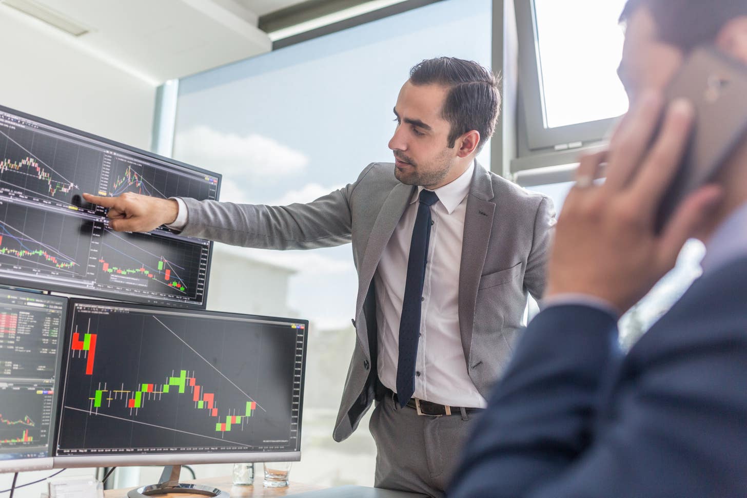 man pointing at a trading chart - Forex Trading Account Types