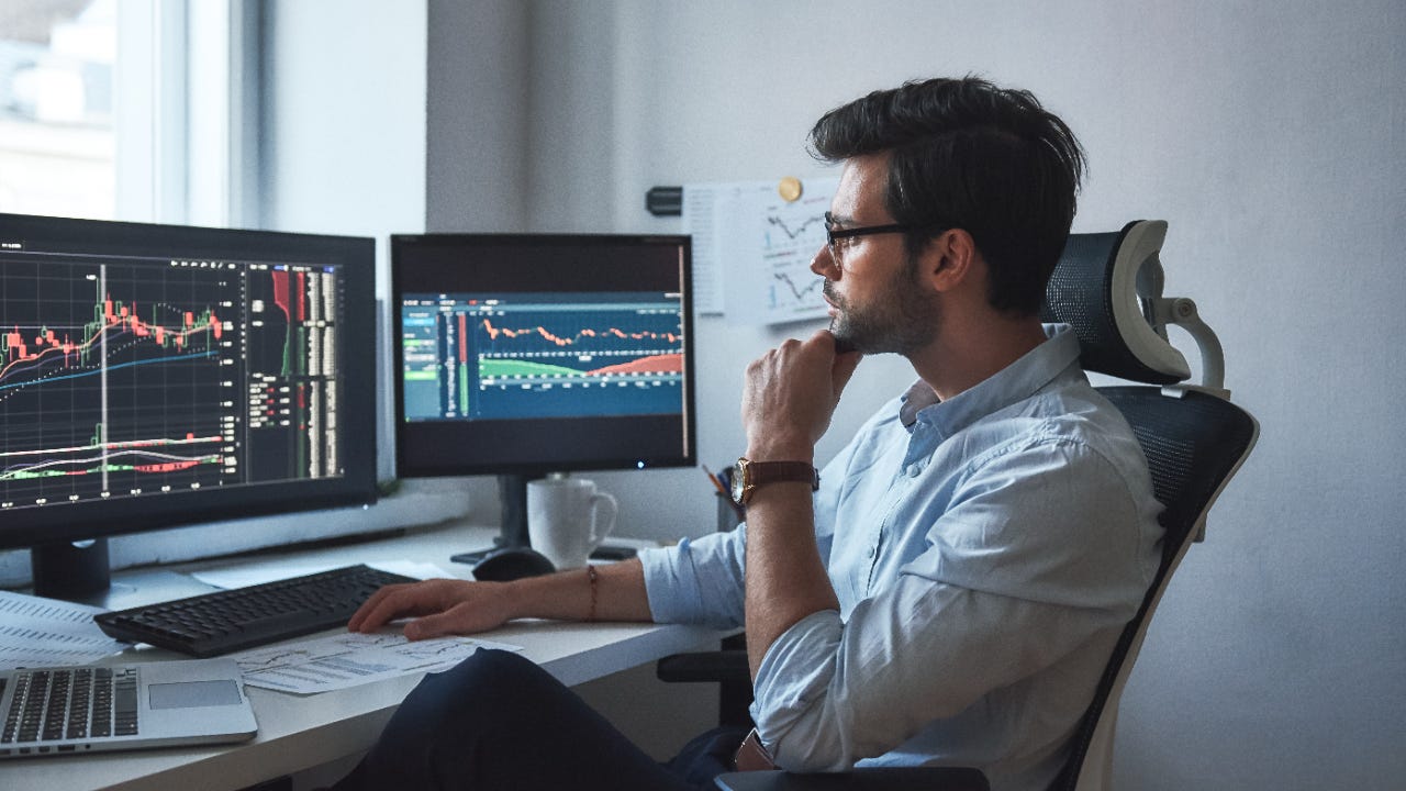 man looking at a trading chart - Fibonacci Forex Trading