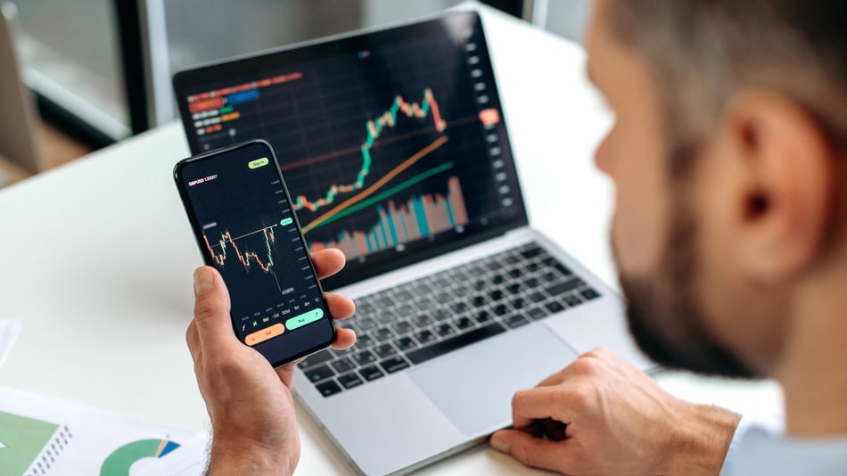 man looking at a trading chart - Forex Trading Vs Crypto Trading