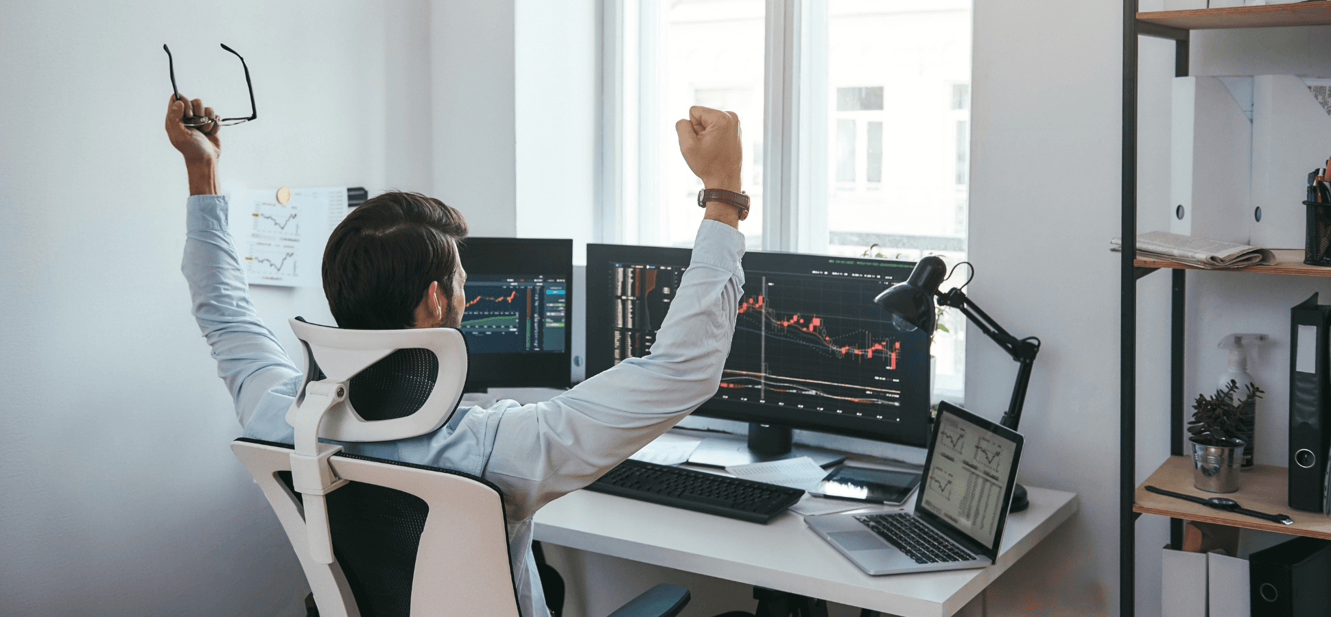 Man celebrating stock market success - How To Start Day Trading For Beginners