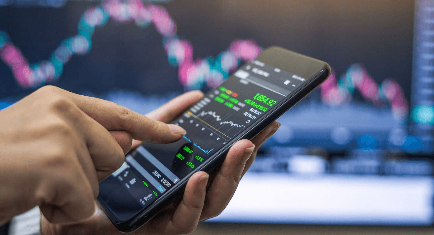 Person trading on smartphone - How To Start Day Trading For Beginners