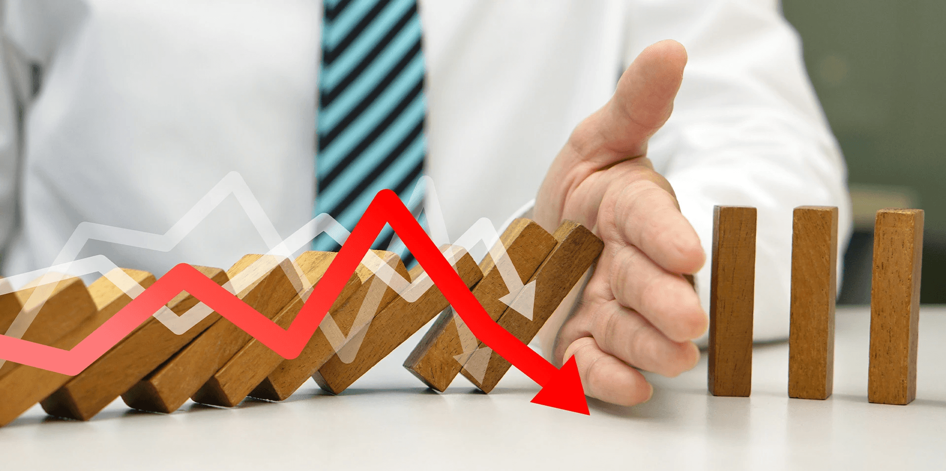 Hand stopping falling dominoes - What Is Stop Loss in Trading