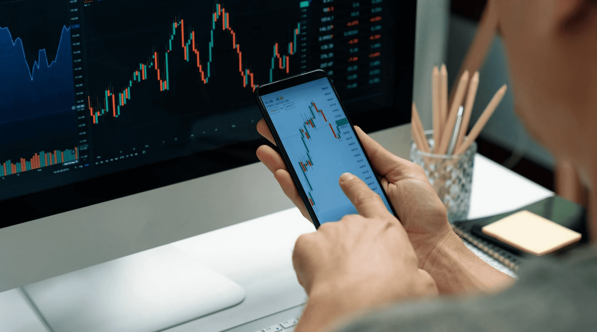 Man analyzing financial charts on a smartphone - Best Day Trading Platform For Beginners