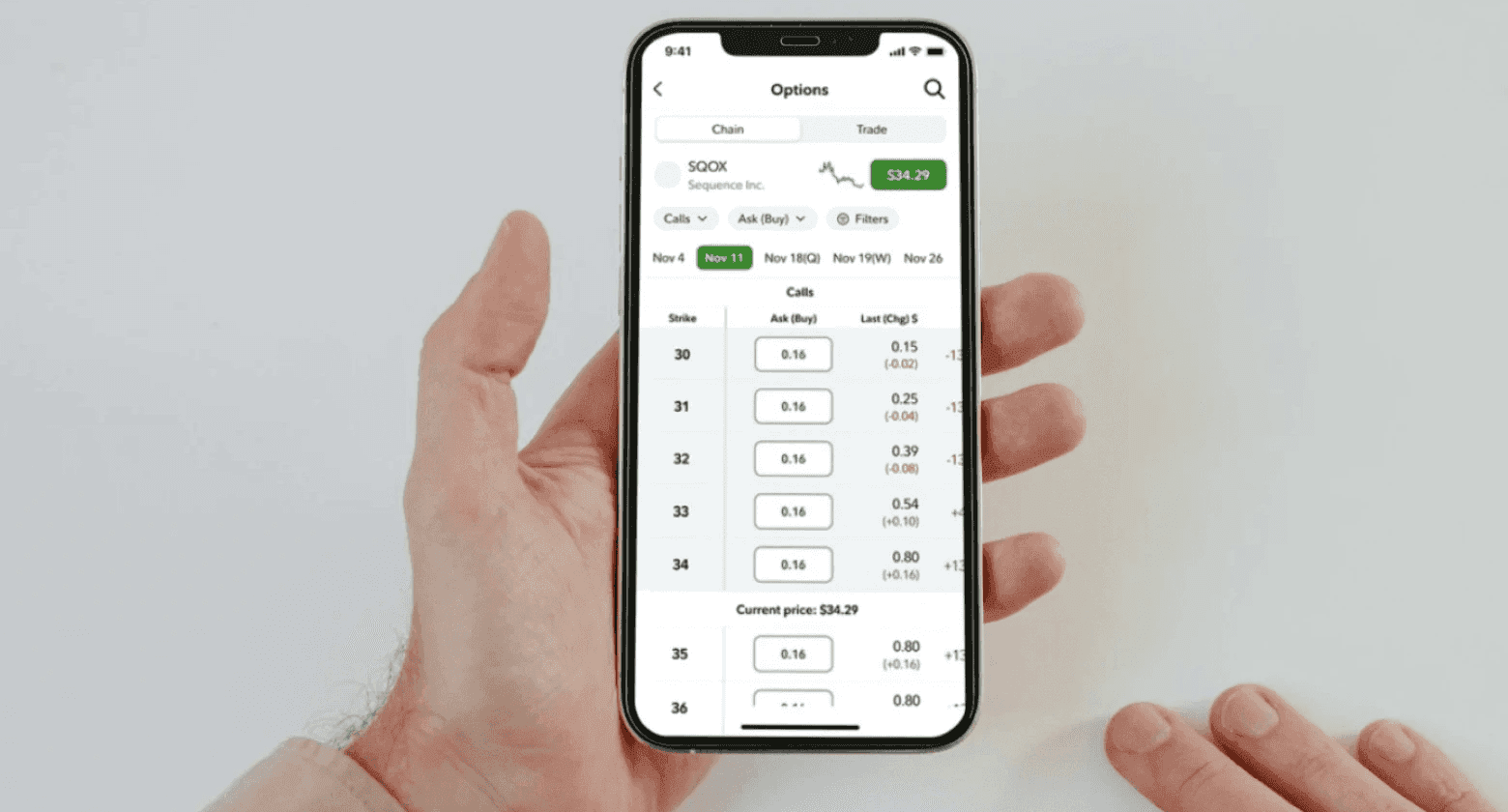 Person holding phone displaying stock options - Best Trading Simulator App