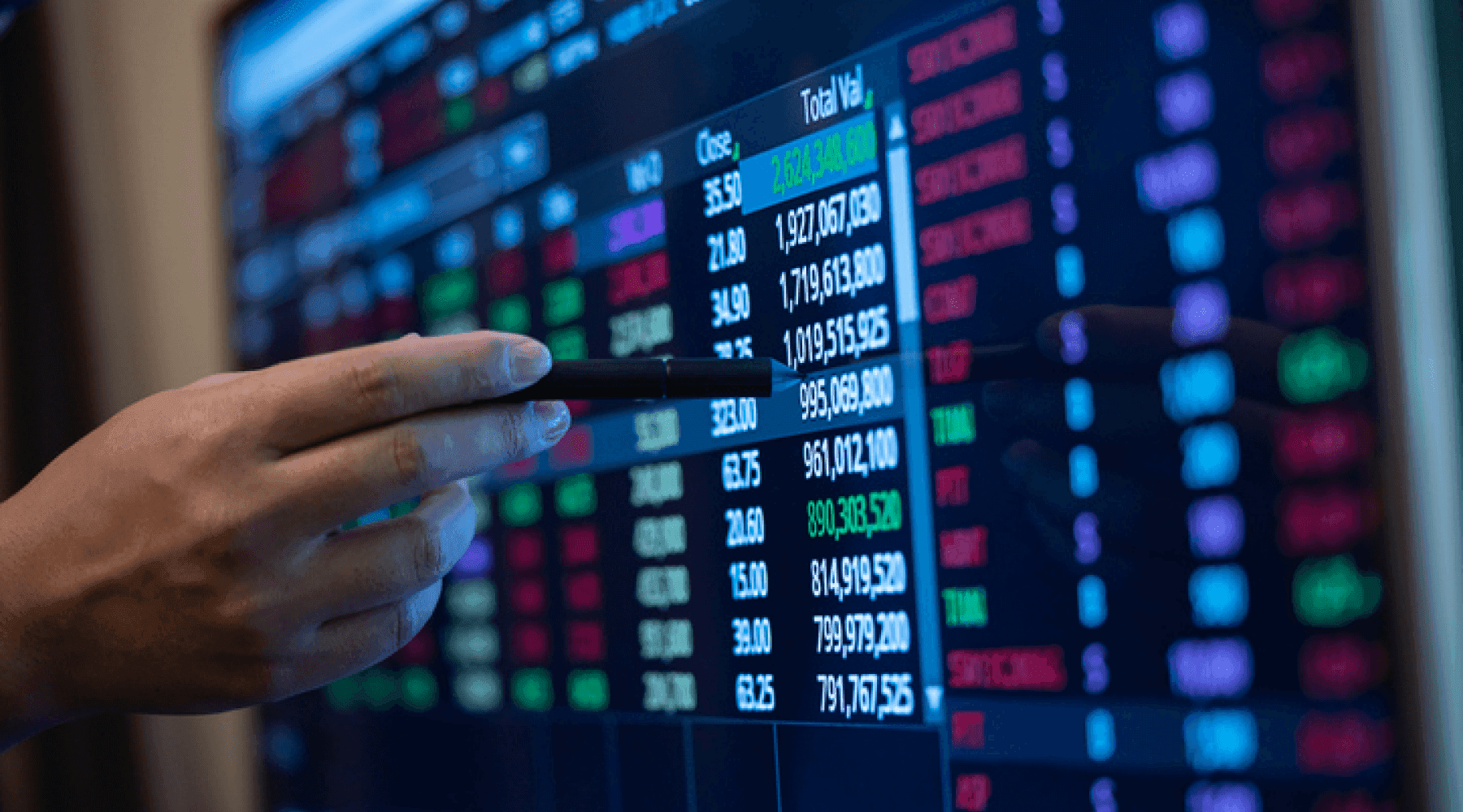 Hand pointing at financial stock data screen - Best Trading Simulator App