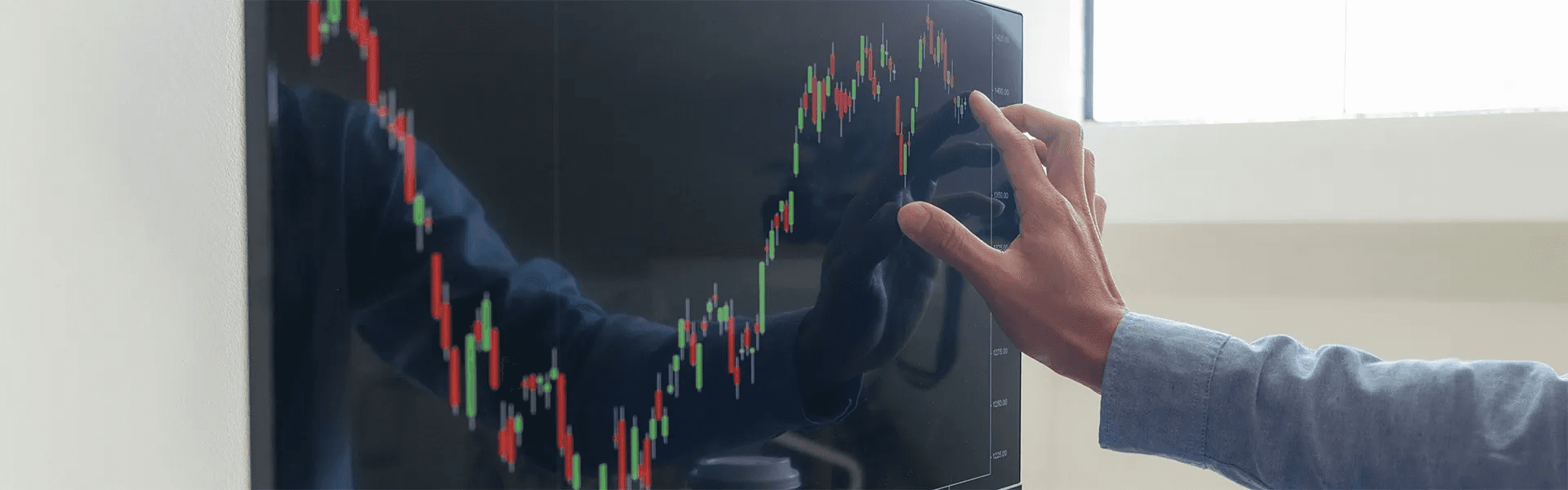 Person touching monitor screen -  What is Arbitrage Trading