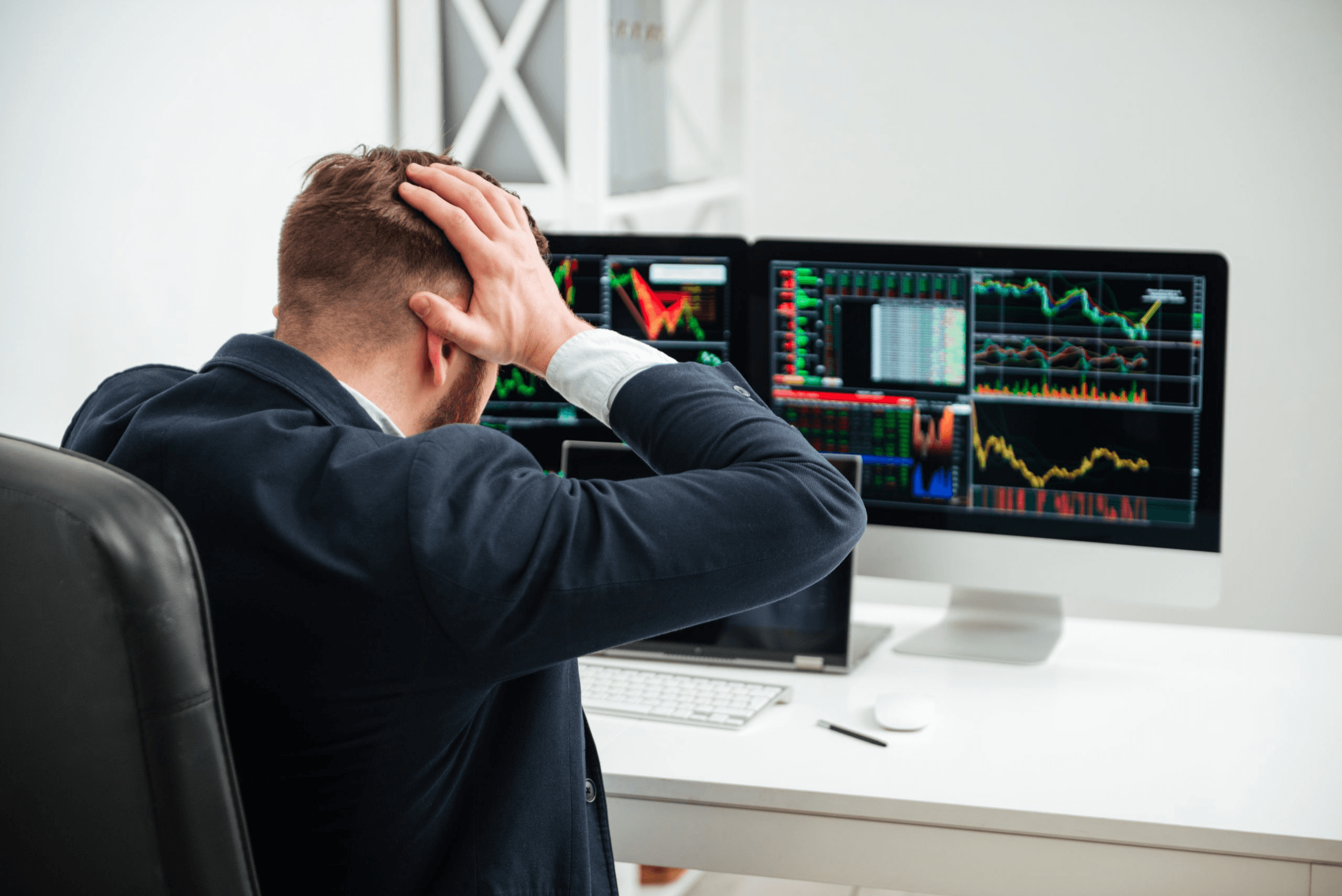 Frustrated trader looking at market losses - What is TP in Trading