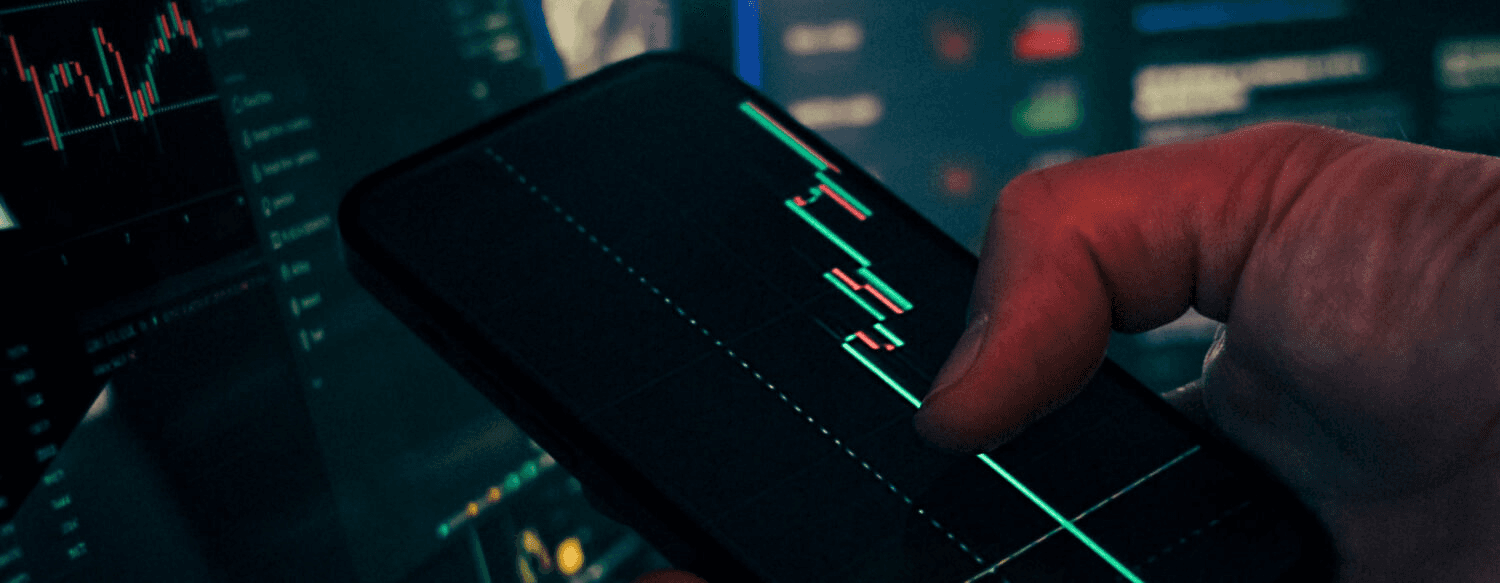 Person tracking stock charts on smartphone - Perpetual Futures Example