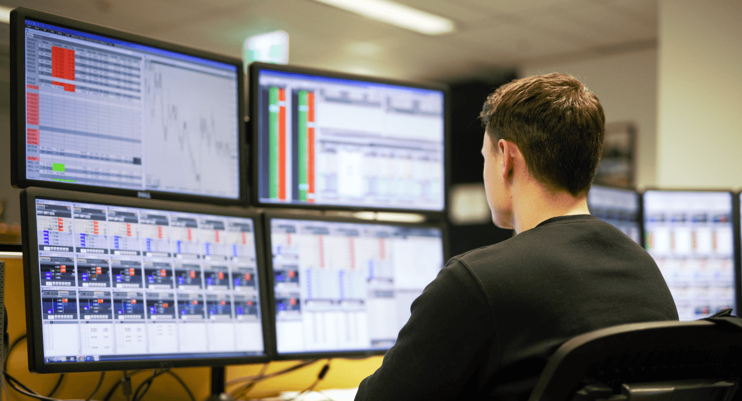 Man monitoring financial data on screens - Proprietary Trading Firms in India