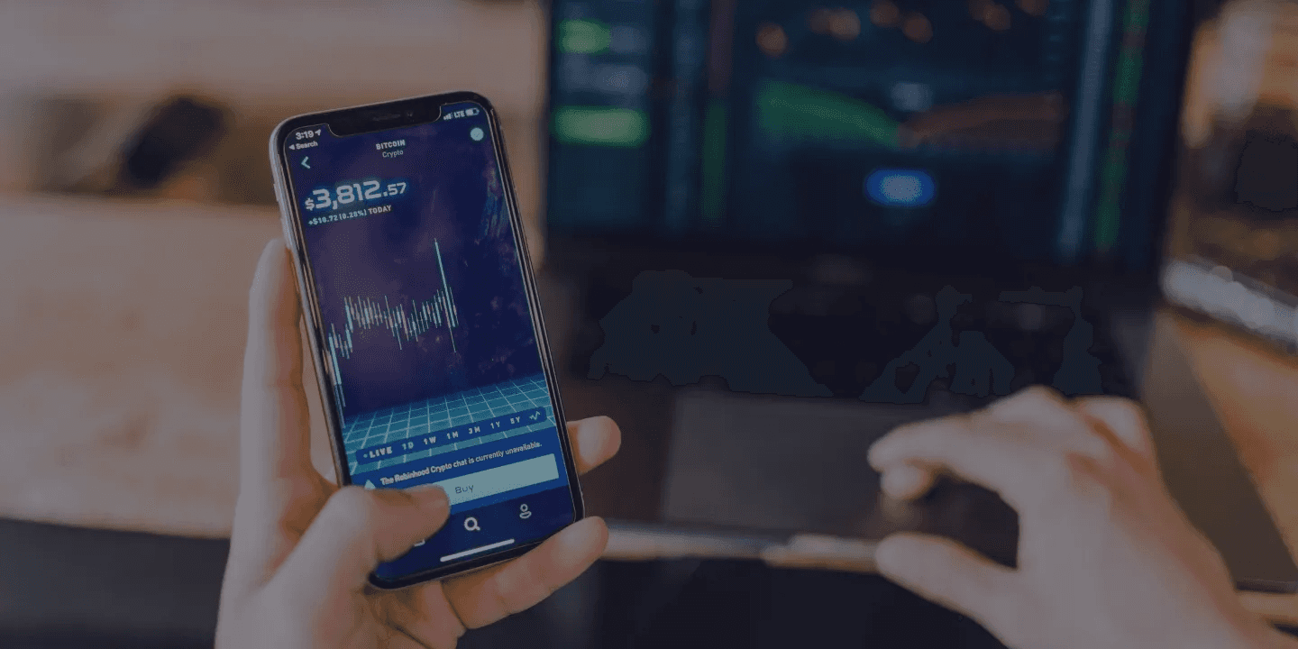 Person holding smartphone showing Bitcoin price chart - Best Prop Firms for Options Trading