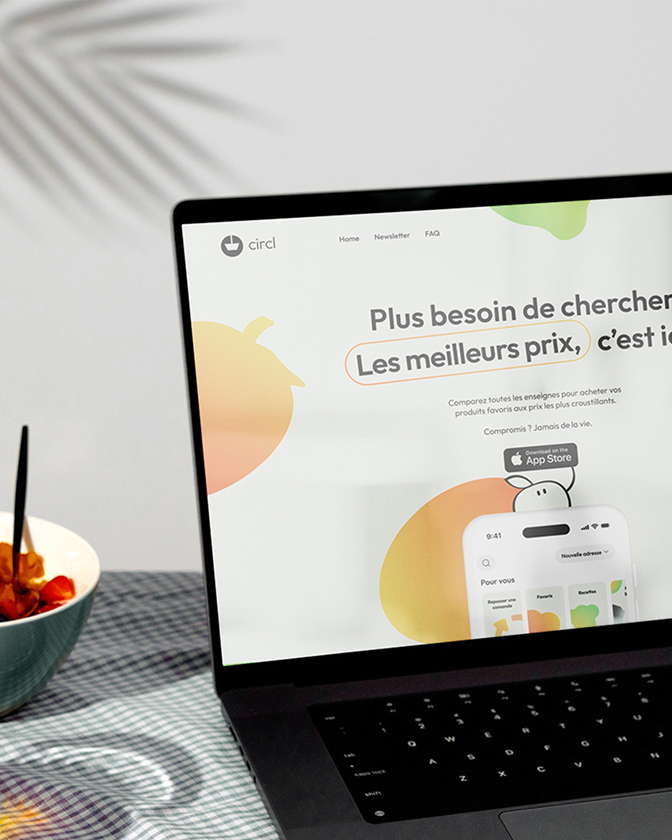 Ordinateur portable ouvert sur une page web d’application avec visuel coloré et texte promotionnel.
