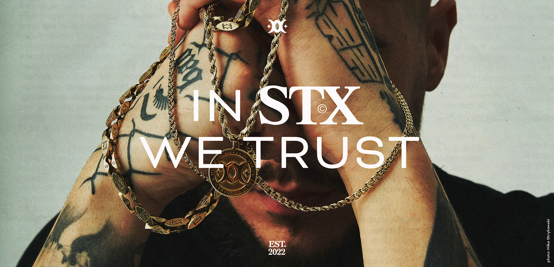 man holding gold chain with a styxxx pedant. "in stx we trust" text place over an image