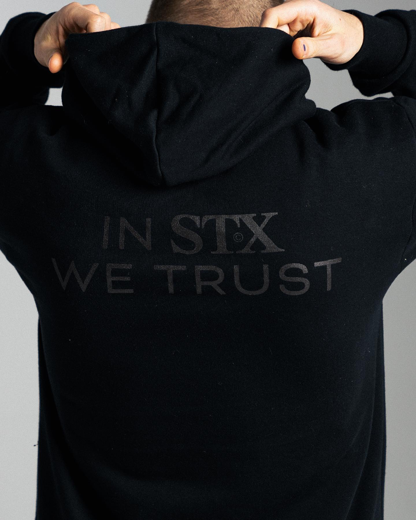 dark grey screenprint design on a black hoodie