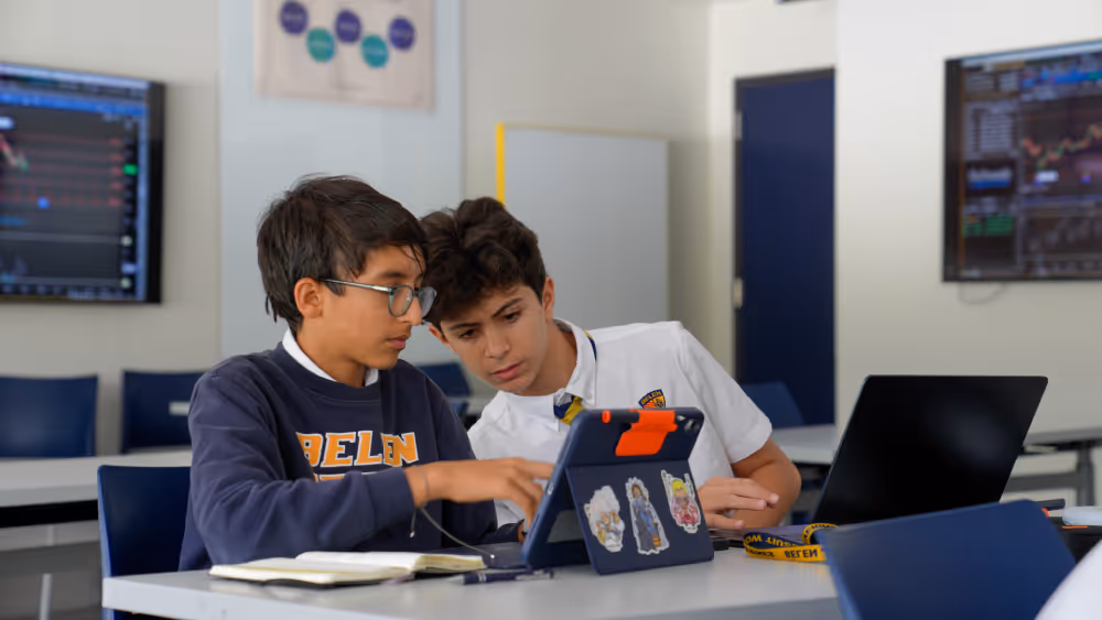 two students at interstock usa doing group study for stock trading in classroom