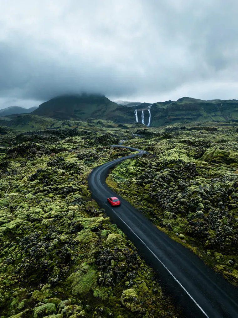 Red car on an Icelandic road