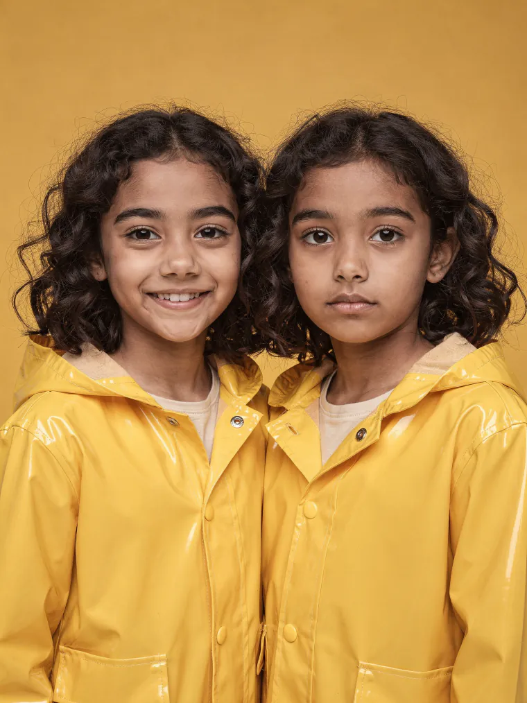 Twins in yellow raincoats