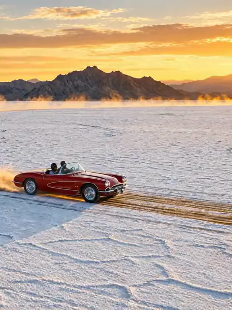 Red convertible on a salt flat