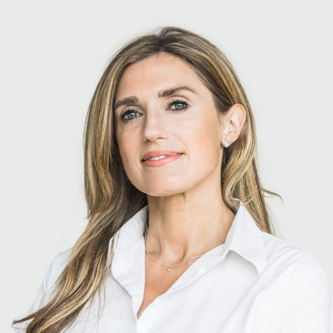 Photo of Laura Barry BSc FCA, Chief Financial Officer of Genomics Ltd, in a white blouse, looking confidently to the side.
