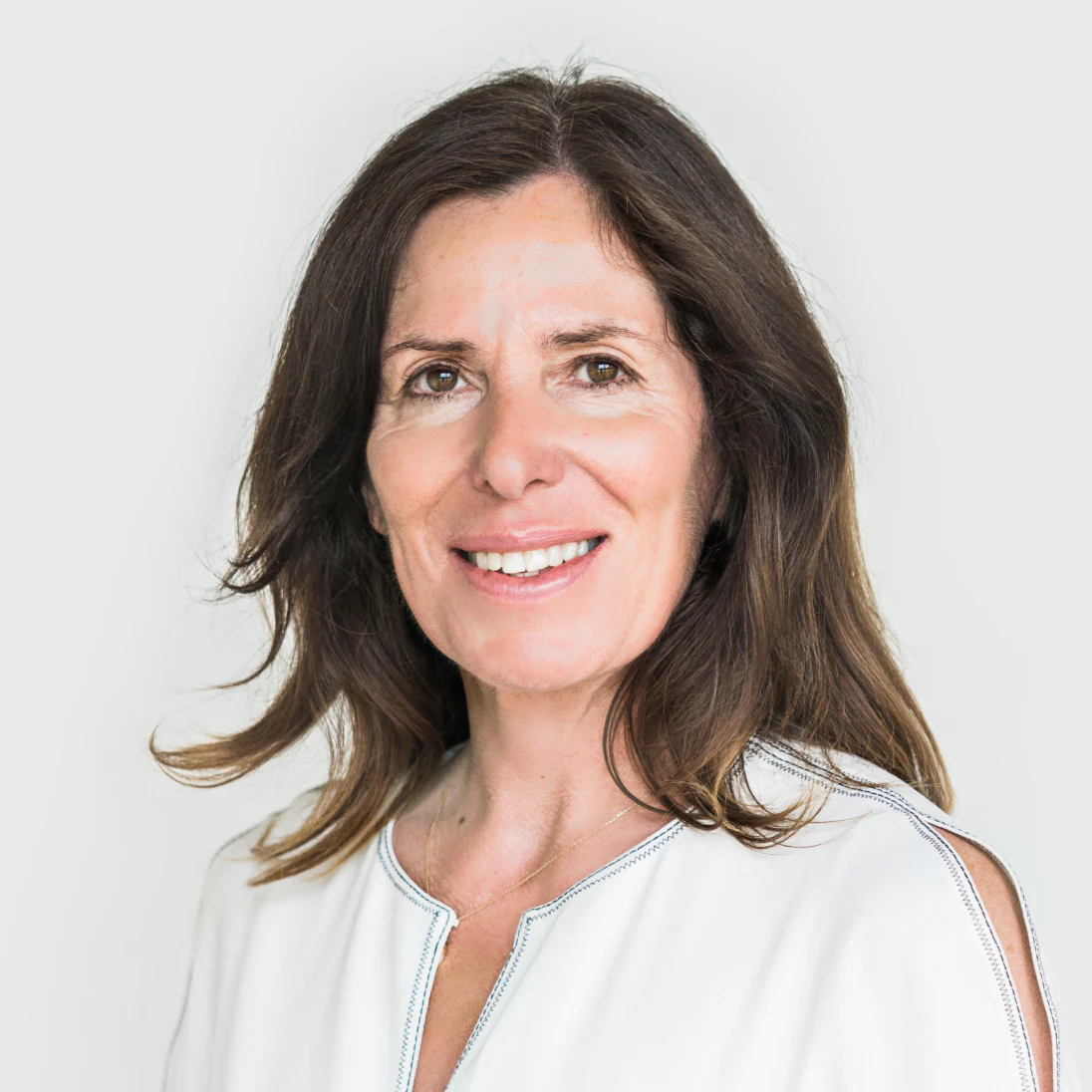 Photo of Sian Jarvis CB FRCGP(H), Chief Policy and Corporate Affairs Officer of Genomics Ltd, smiling in a light top.