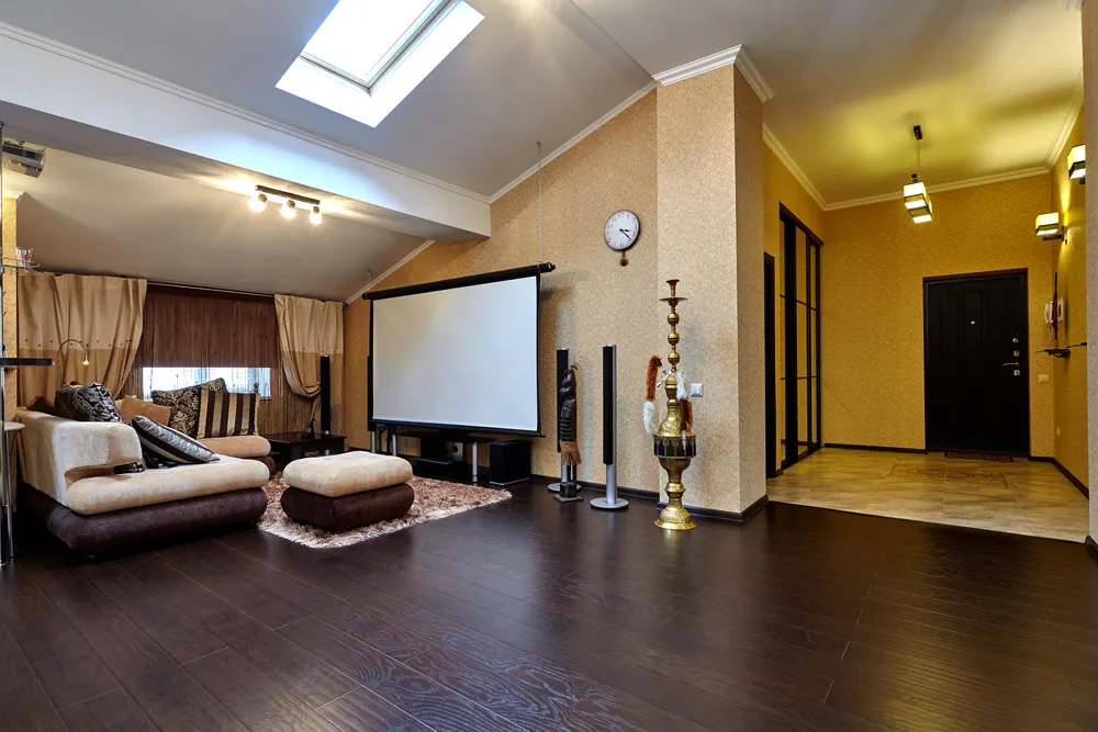 Soundproofed basement family entertainment room with large sectional sofa and mounted television