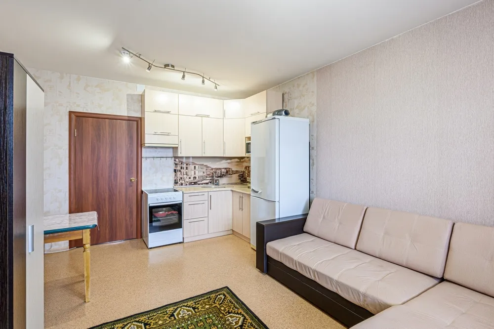 Legal basement ADU conversion in Bellevue, WA, showing a compact but full kitchen and living area