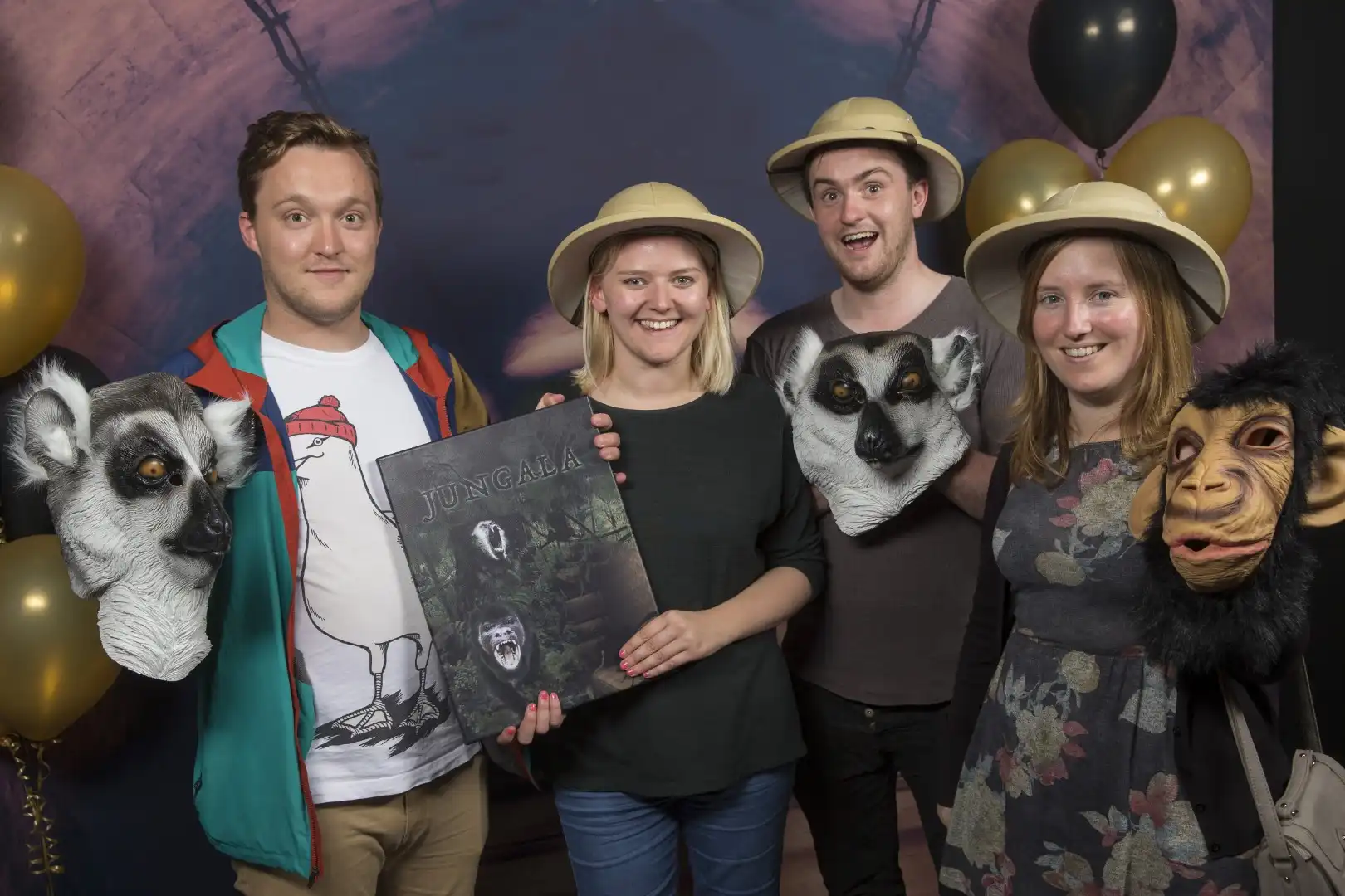 Colleagues laughing together as they solve puzzles during a Christmas office party escape room experience.