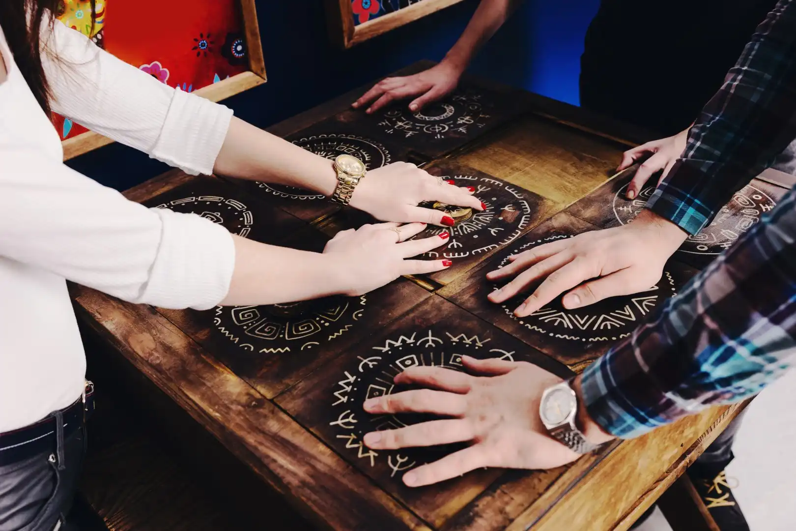 Escape room players gathered around a cryptic puzzle, working together to decipher the clues