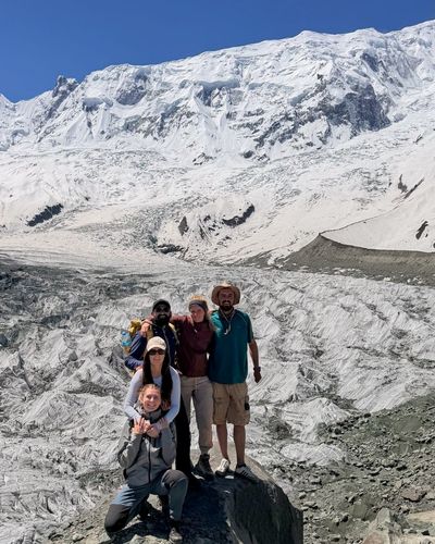 Hikers standing on the glacier at Rakaposhi base camp, Pakistan