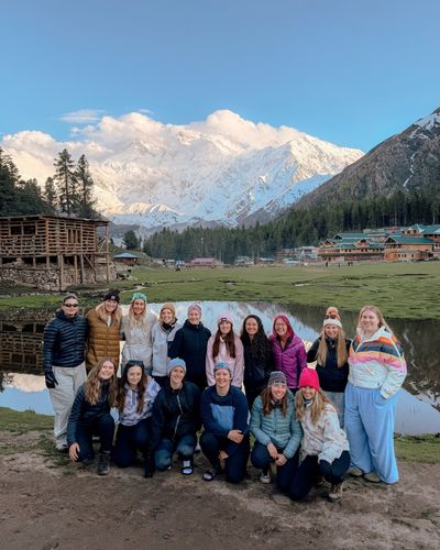 Stay Wild group at Fairy Meadows with Nanga Parbat behind them, Pakistan