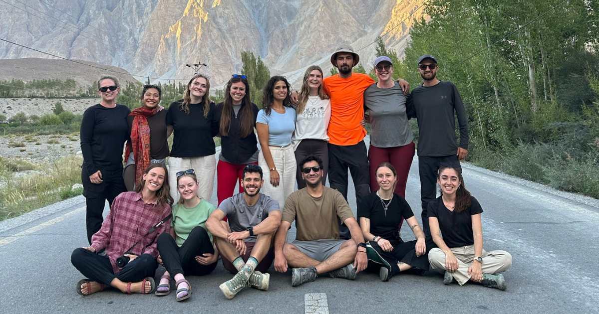 Stay Wild group posing on a mountain road in northern Pakistan