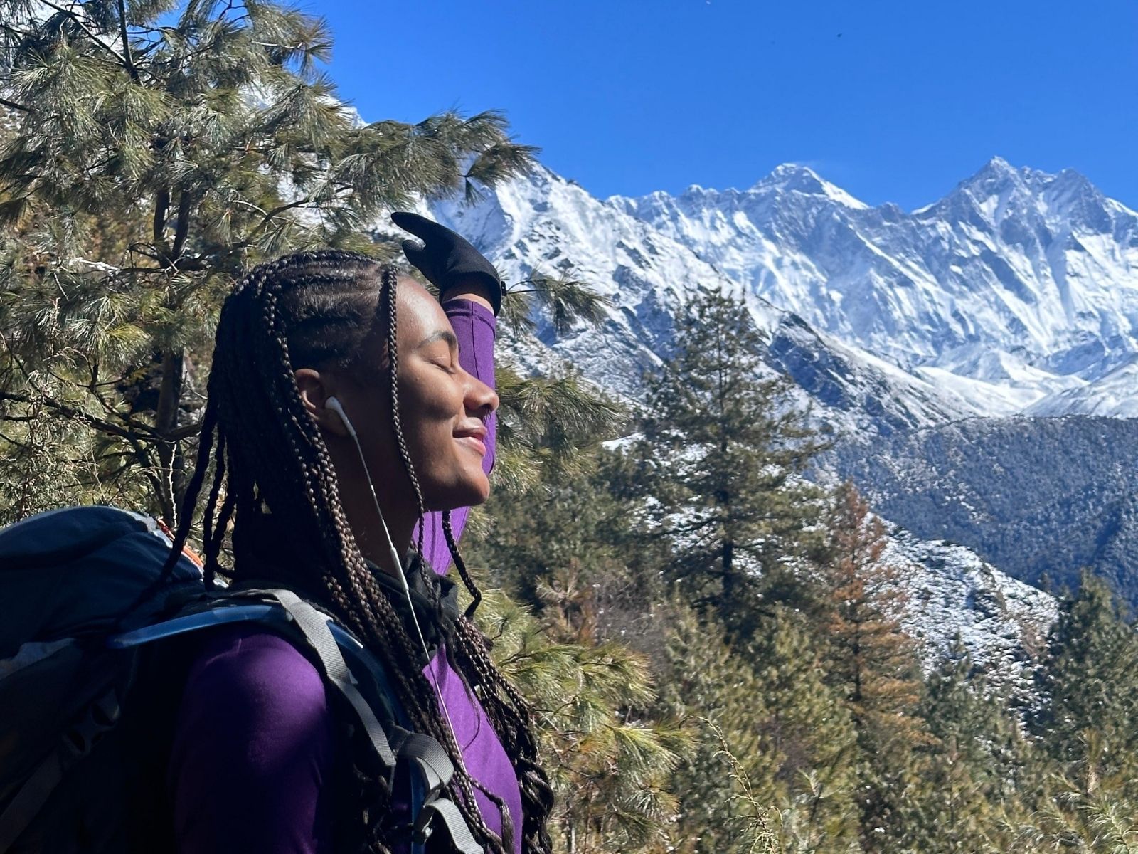 Woman looking out at snow-covered mountains in northern Pakistan