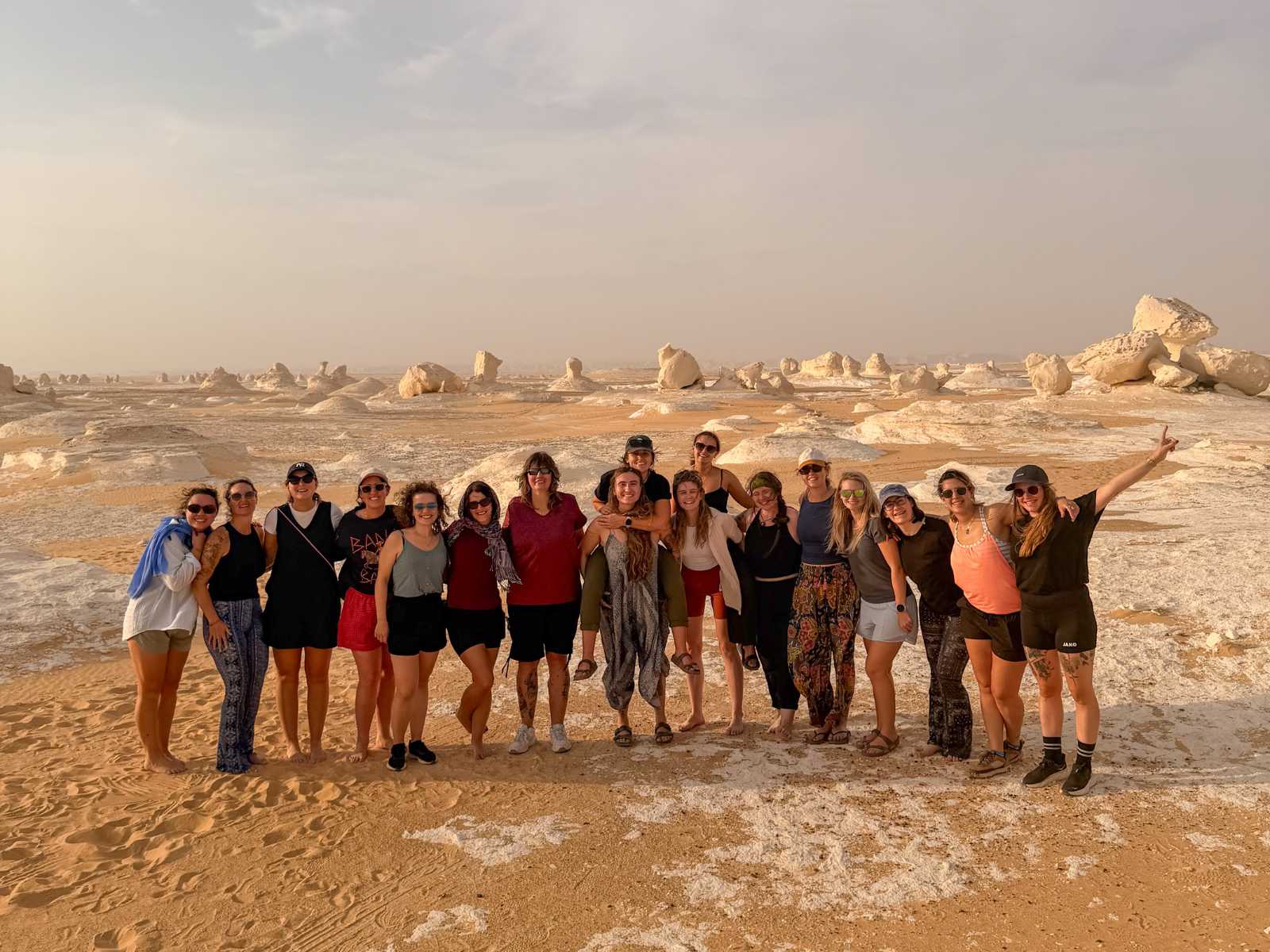 Stay Wild group standing among the chalk formations of the White Desert, Egypt