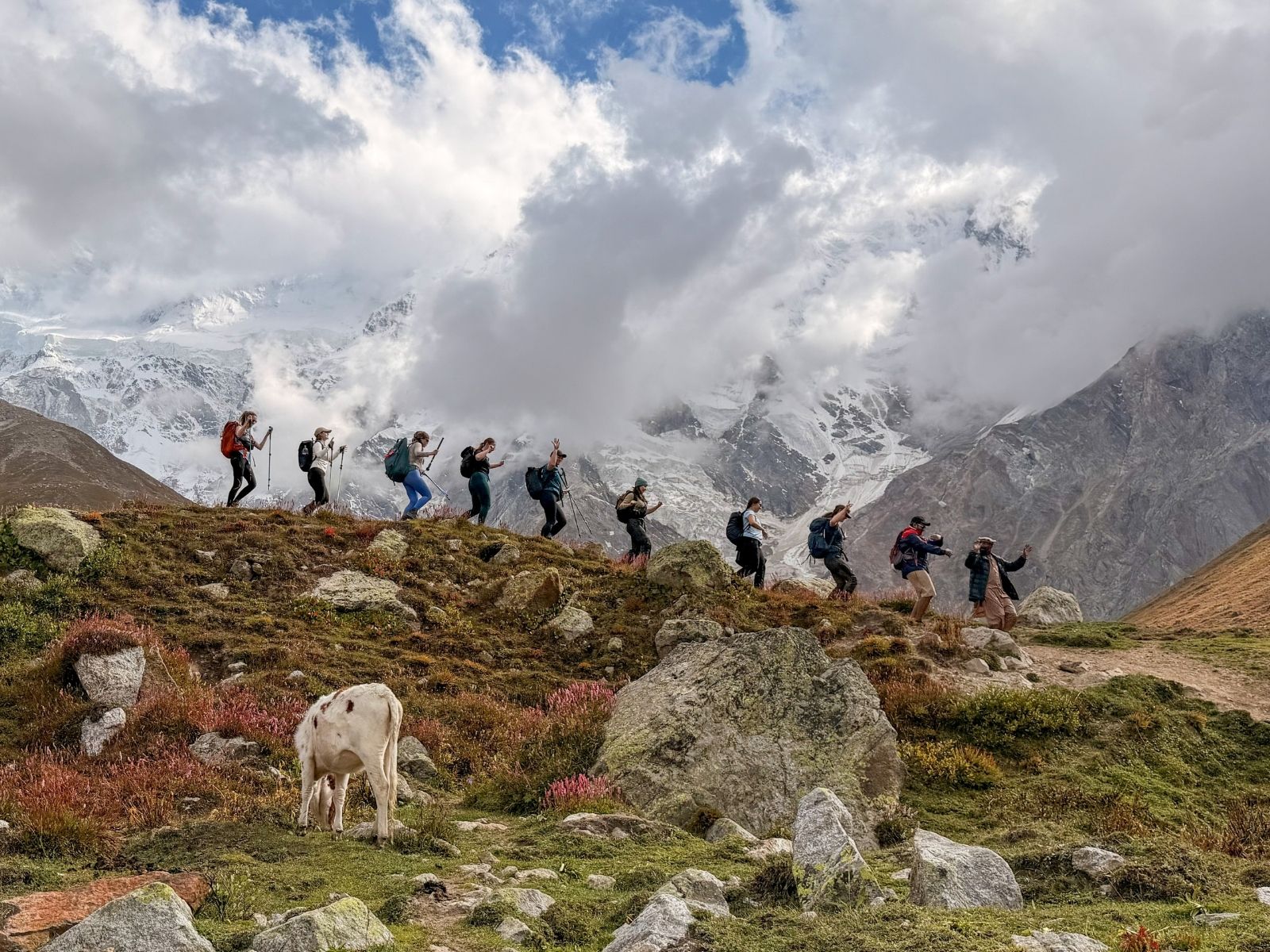 Line of hikers on a ridge beneath Nanga Parbat, Pakistan